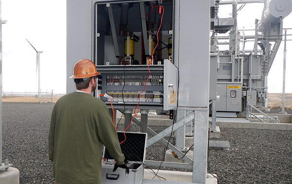 Field service technician vacuum interrupter testing wind farm